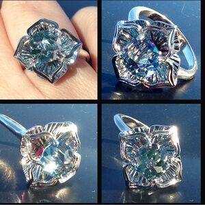 Beautiful 14k blue topaz with emerald and rubies underneath.  Beautiful piece!